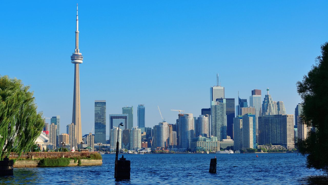 Toronto skyline in the day over lake with urban architecture viewed from park